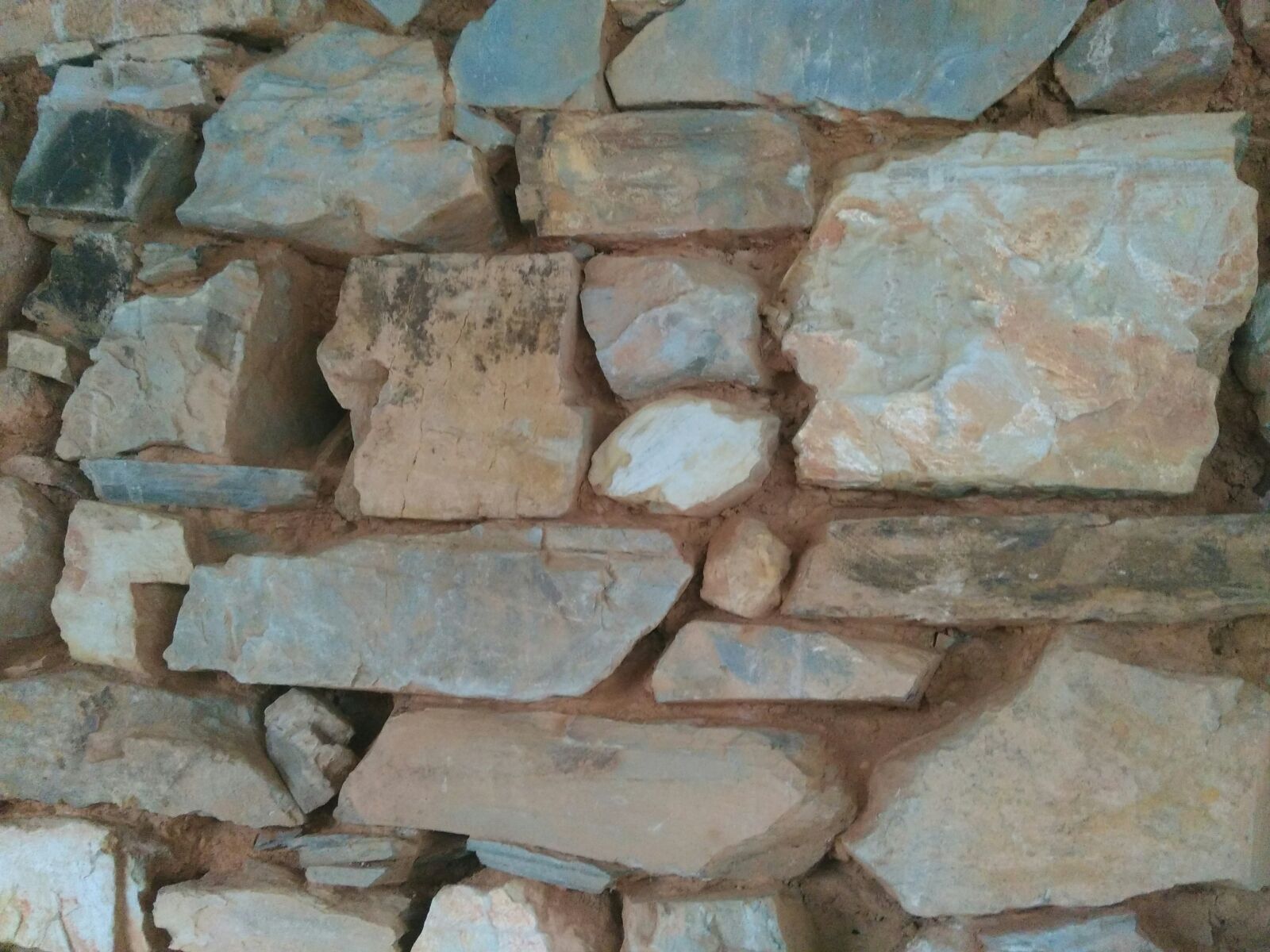 Detail of a cleaned patch of stonework wall prior to repointing it.
